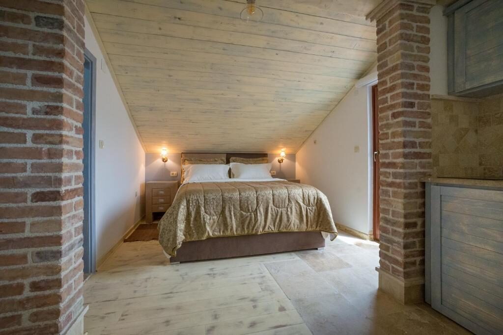 Apartment bedroom framed by brick columns