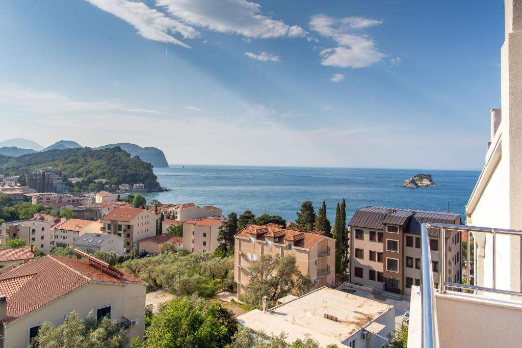 Panorama of Petrovac coastline, olive groves and mountains