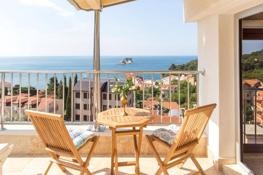 Balcony with wooden table overlooking the sea and Katic island