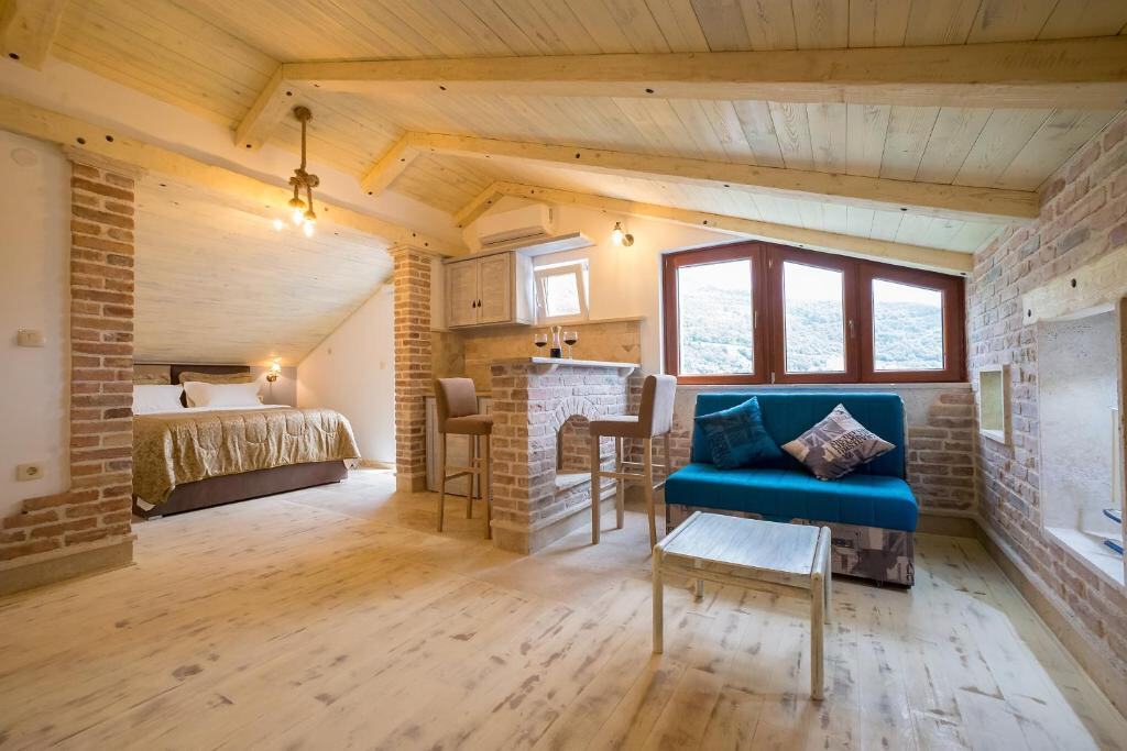 Spacious apartment with stone walls, bedroom and living area